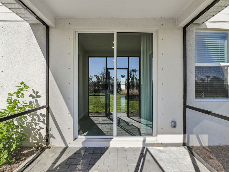 Exterior details and patio area of a home in Crescent Lakes - Premier Series, Punta Gorda (Image 4).