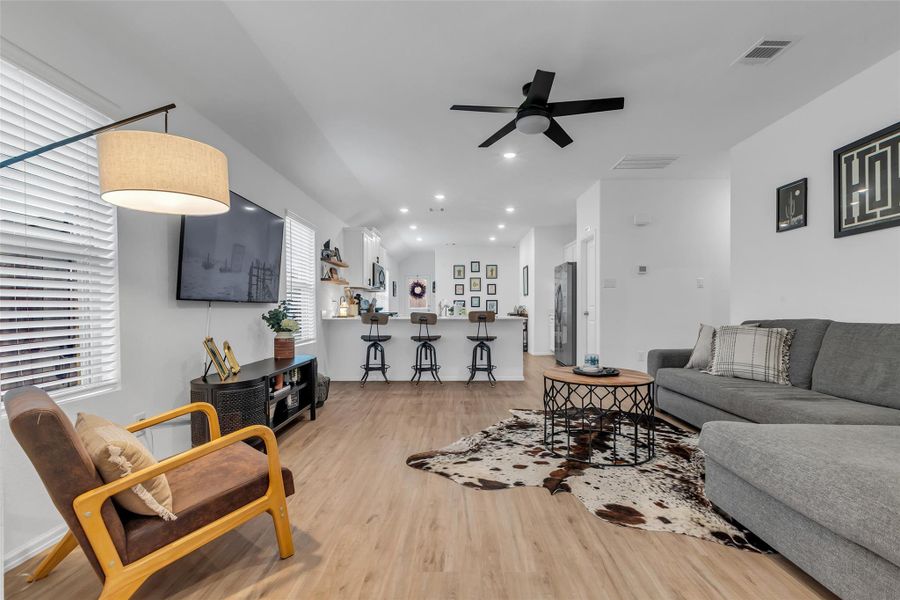 This open concept home is perfect for the family. Here's a picture of the family room, spacious kitchen and dining area. This family room is large and can accommodate family members or guest.