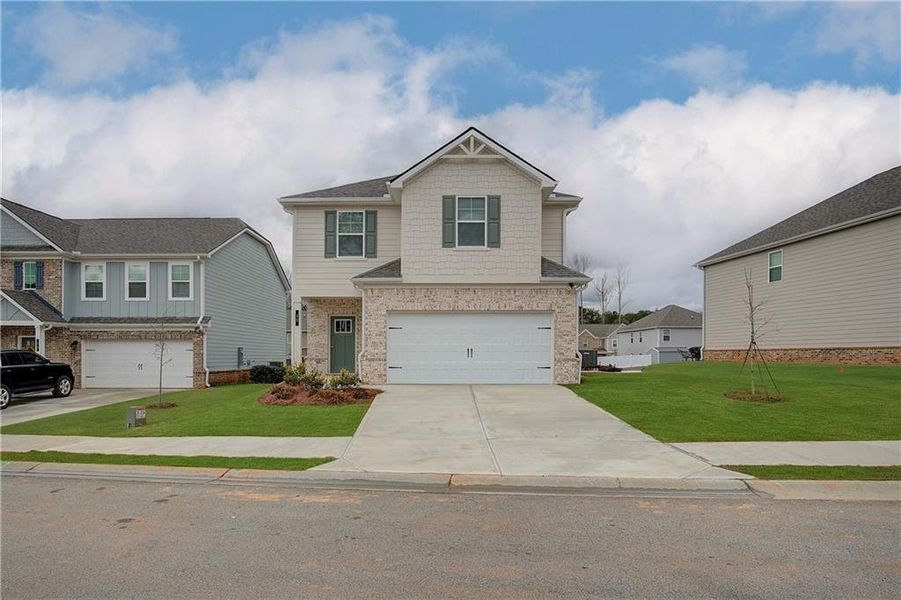 Front exterior of a new home in Towne Center, Hampton, GA, highlighting curb appeal (Image 20).