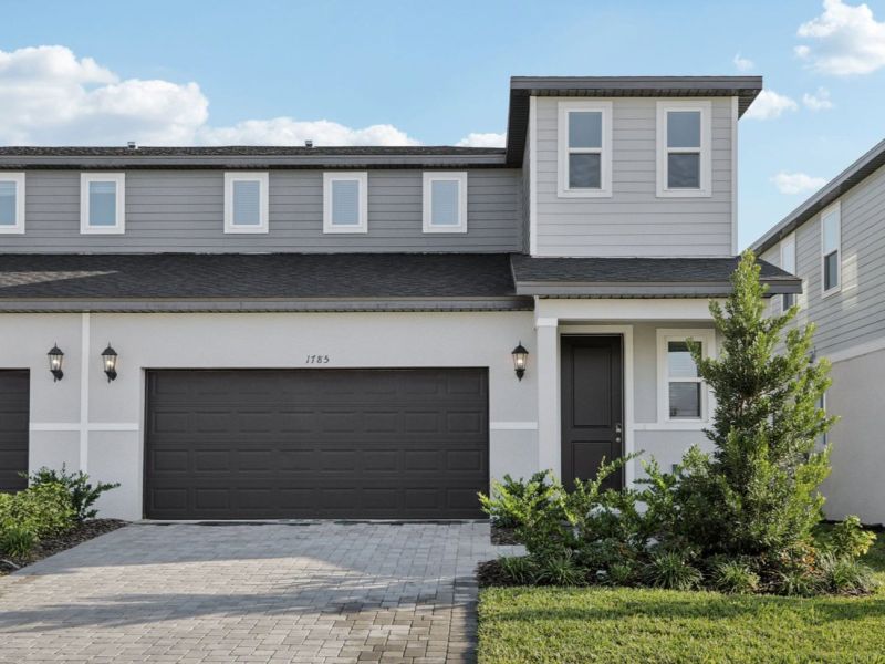 Front exterior of a new home in Cyrene at Minneola - Villas, Minneola, FL, highlighting curb appeal (Image 1). Front exterior of a new home in Cyrene at Minneola - Villas, Minneola, FL, highlighting curb appeal (Image 1).