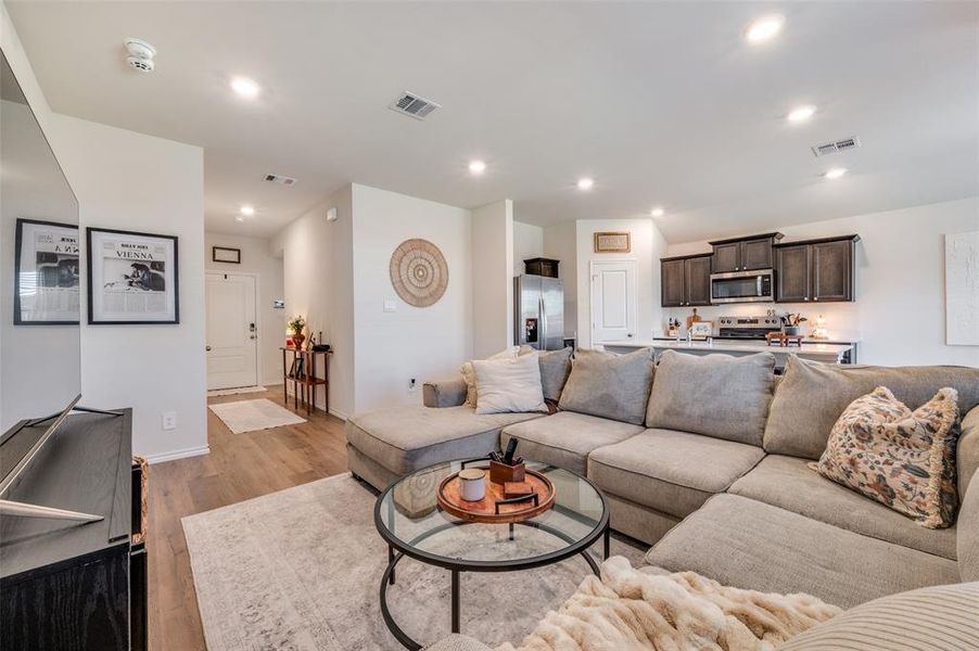 Living area with recessed lighting and light wood-style floors