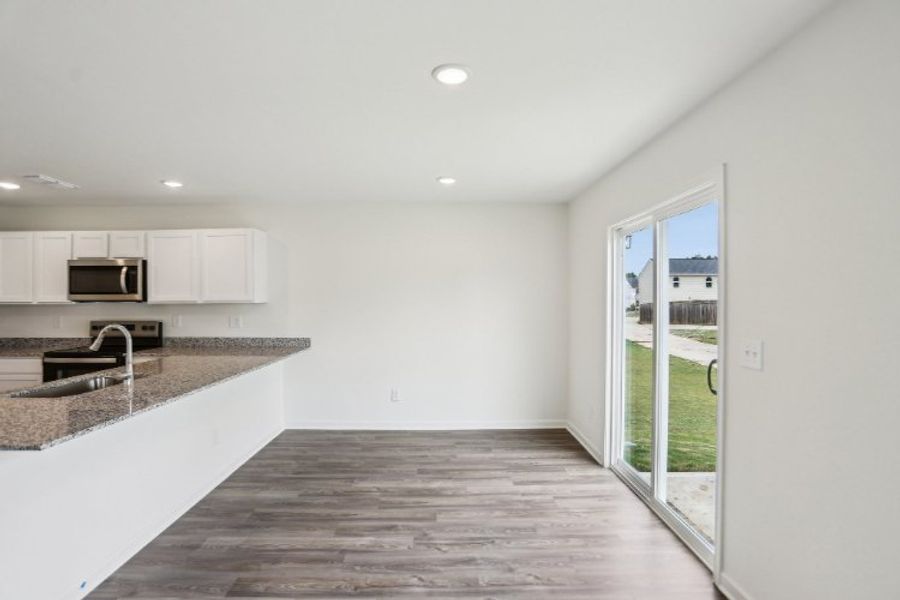A kitchen with a large glass door.