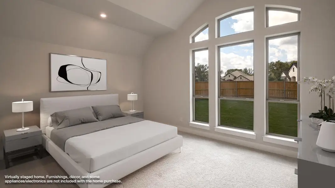 Carpeted bedroom with vaulted ceiling and recessed lighting
