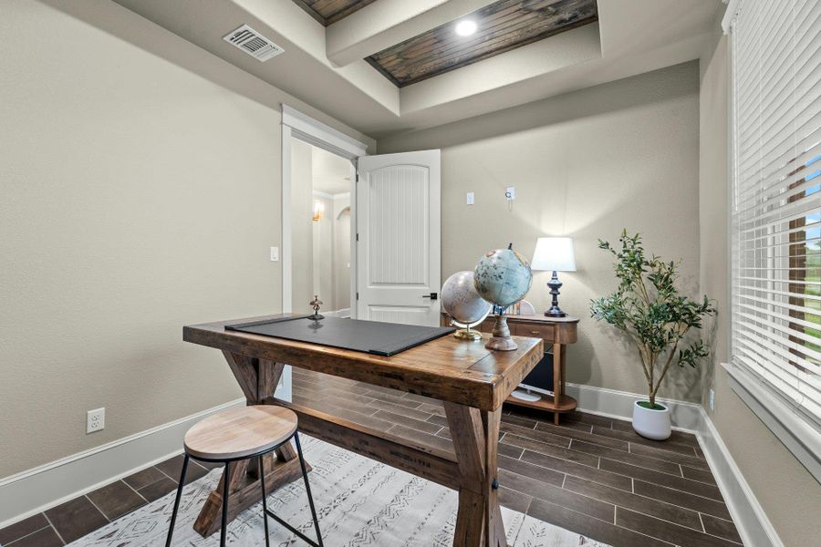 Room featuring wood-finish flooring, a coffered ceiling with a wood panel insert, and light-colored walls