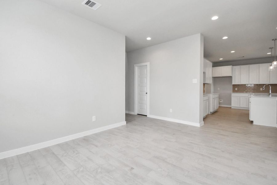Craft enduring memories with loved ones around the table in this roomy dining area. It boasts stylish flooring, personalized paint, and is conveniently situated next to the family room and kitchen, fostering an open and inclusive ambiance. Sample photo of completed home with similar floor plan. Actual colors and selections may vary. Craft enduring memories with loved ones around the table in this roomy dining area. It boasts stylish flooring, personalized paint, and is conveniently situated next to the family room and kitchen, fostering an open and inclusive ambiance. Sample photo of completed home with similar floor plan. Actual colors and selections may vary.