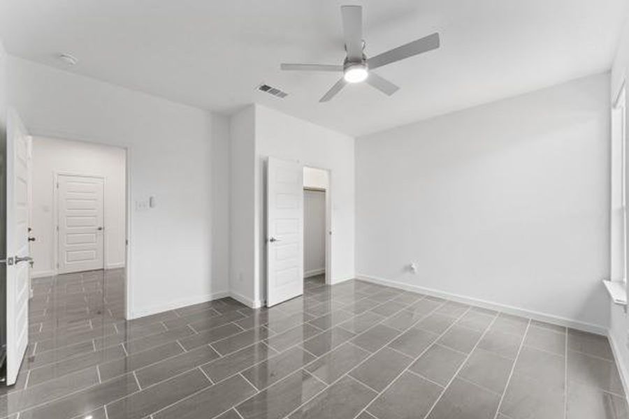 Unfurnished bedroom featuring a spacious closet and ceiling fan Unfurnished bedroom featuring a spacious closet and ceiling fan