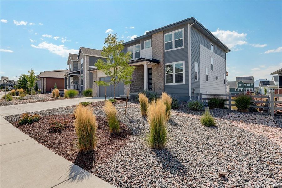 Front exterior of a new home in , Littleton, CO, highlighting curb appeal (Image 1).