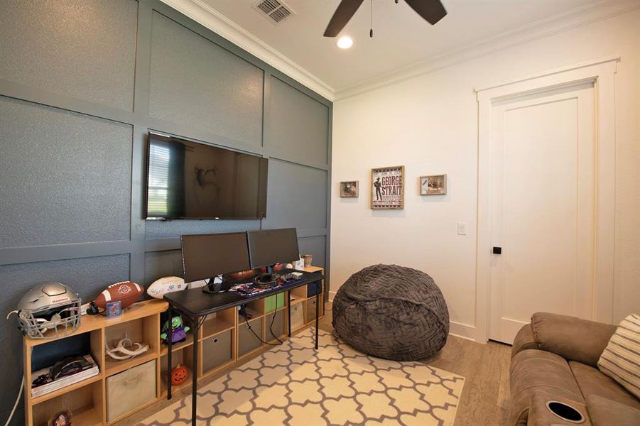 Playroom with light wood-type flooring, crown molding, recessed lighting, a ceiling fan, and an office area