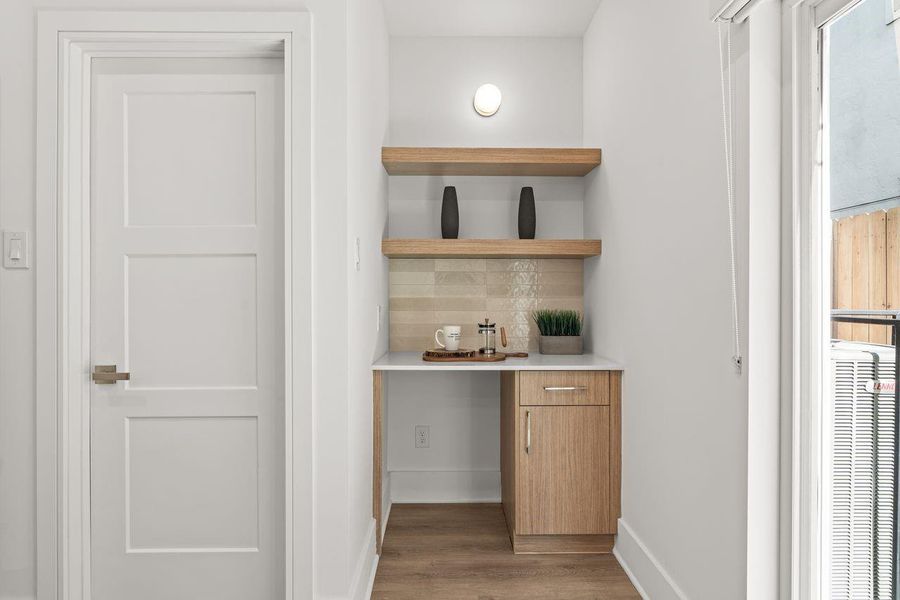 Integrated shelving and cabinetry provide practical storage solutions while adding depth, character, and versatility to the space.