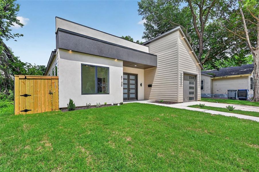 Contemporary exterior featuring a flat roofline, stucco facade, and horizontal siding accents Contemporary exterior featuring a flat roofline, stucco facade, and horizontal siding accents