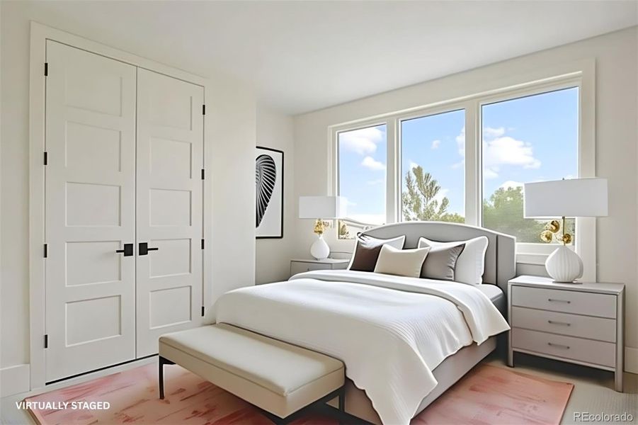 Lower-level bedroom (bedroom 2) with a large closet and en suite bathroom.*This photo has been virtually staged Lower-level bedroom (bedroom 2) with a large closet and en suite bathroom.*This photo has been virtually staged