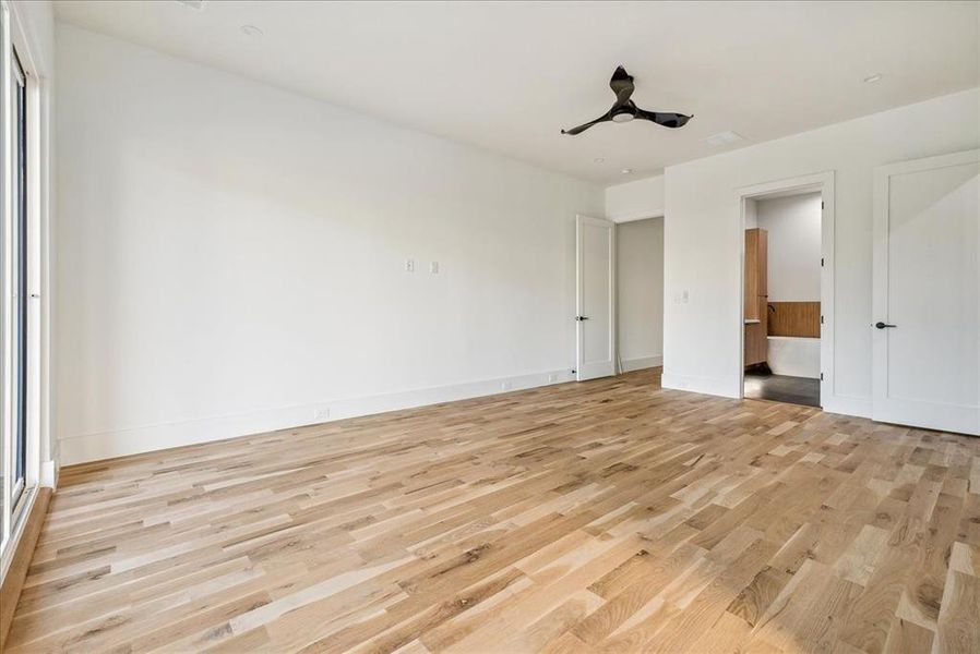 Unfurnished bedroom featuring light wood-type flooring and ceiling fan