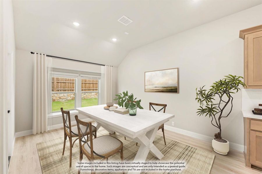 Dining area with white farmhouse table, wood chairs, vaulted ceiling, and large window with backyard view Dining area with white farmhouse table, wood chairs, vaulted ceiling, and large window with backyard view