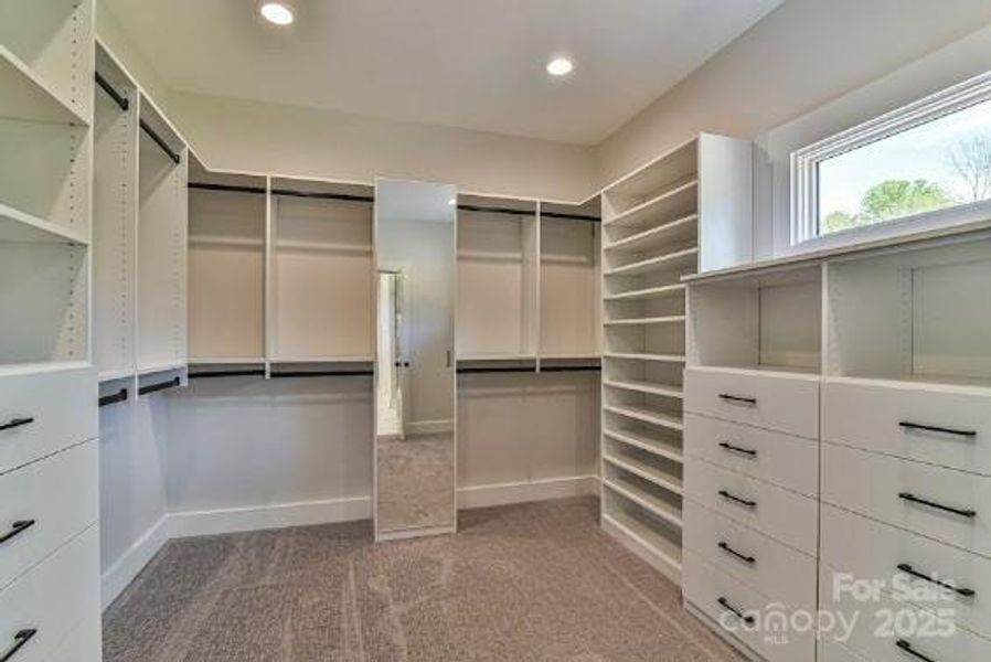 Primary Closet with lots of storage.Similar photo.