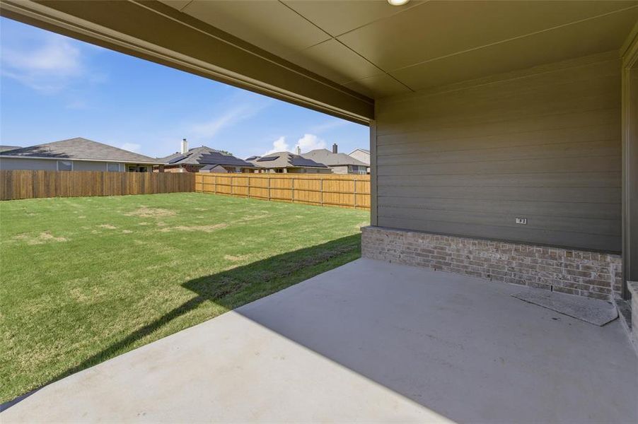 Fenced backyard with a patio and a residential view