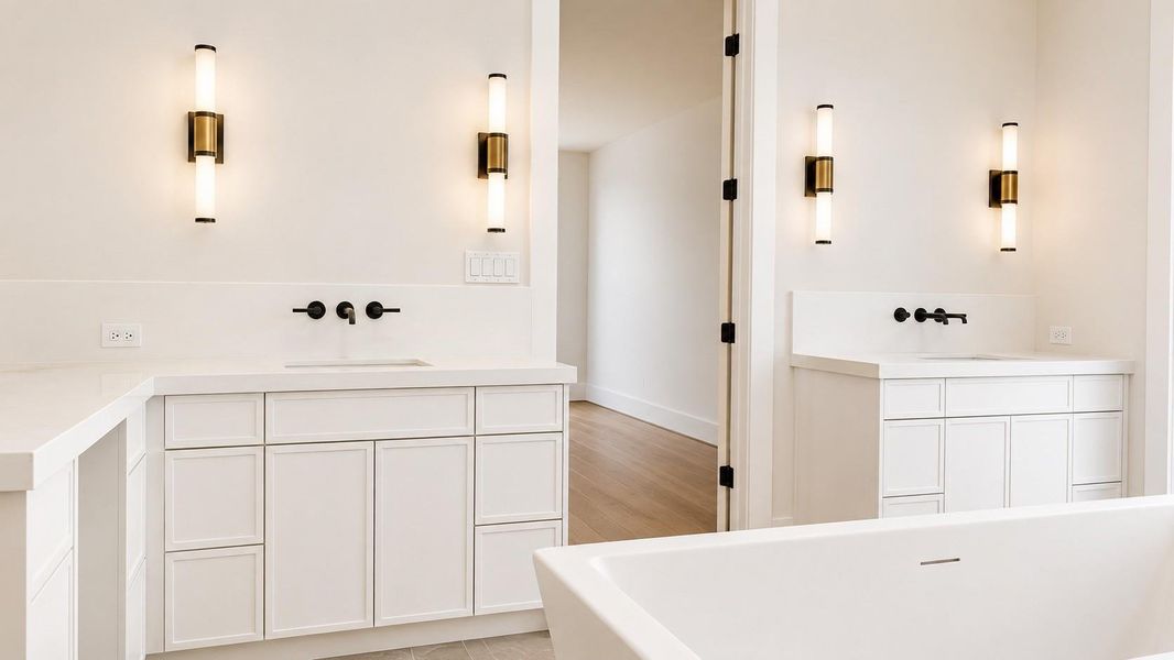 Primary bath with dual vanity, custom cabinets, and marble finishes.