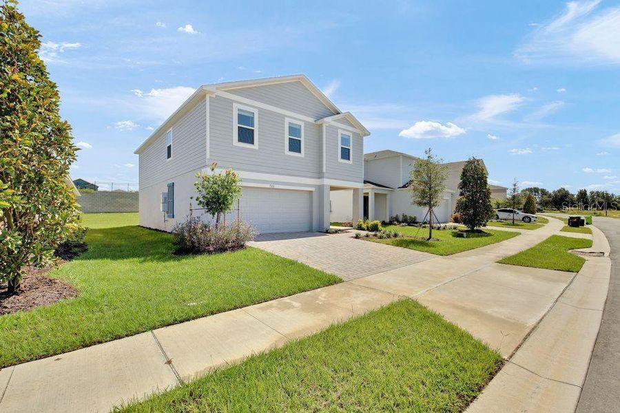 Front exterior of a new home in Waterstone, Groveland, FL, highlighting curb appeal (Image 2). Front exterior of a new home in Waterstone, Groveland, FL, highlighting curb appeal (Image 2).