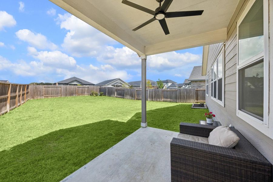 The back yard is a lush, green retreat offering so much space to relax, play, or entertain family and friends.
