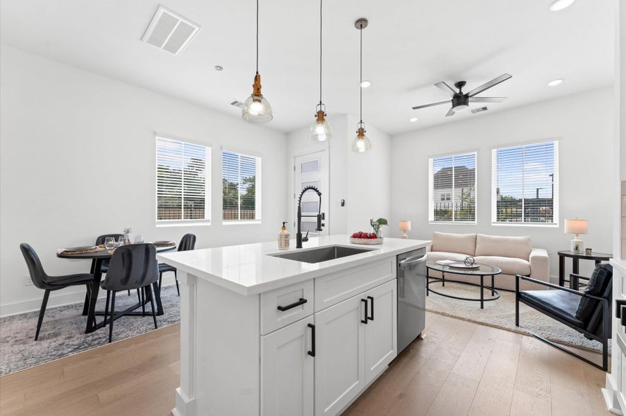 At the heart of this open-concept kitchen lies a stunning oversized island, offering generous prep space, sleek quartz countertops, and seating area. Whether you're hosting a dinner party or enjoying a casual breakfast, this island is the perfect gathering spot. Pendant lighting adds a touch of elegance, and the deep sink makes it as functional as it is beautiful.
