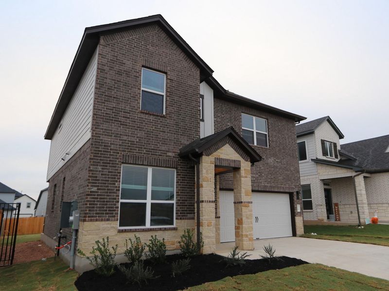 Front exterior of a new home in Cascades at Onion Creek, Austin, TX, highlighting curb appeal (Image 12). Front exterior of a new home in Cascades at Onion Creek, Austin, TX, highlighting curb appeal (Image 12).