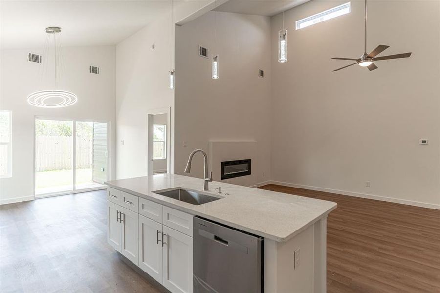 Kitchen, dining and living area with doorway to master bedroom