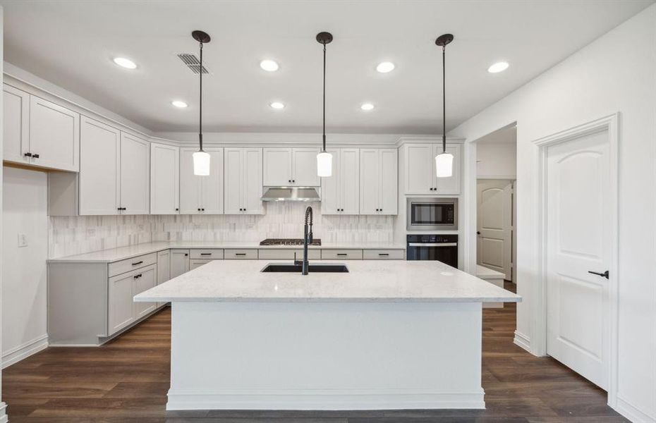 Spacious kitchen with oversized island *real home pictured