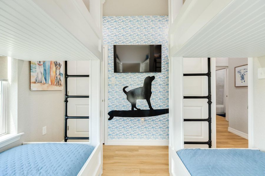 Built-in bunk beds with integrated ladders maximize sleeping space while maintaining an open, inviting feel.