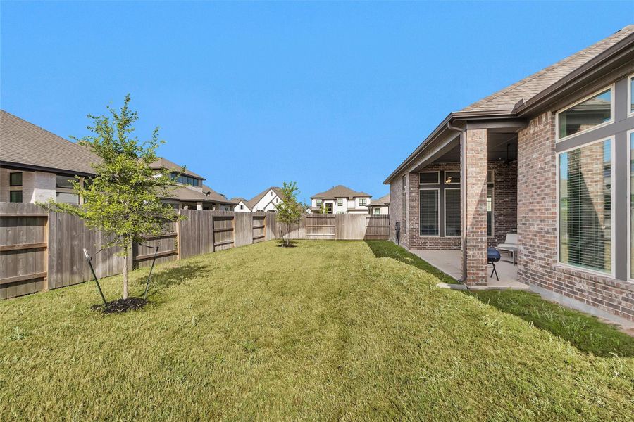 Exterior details and patio area of a home in Artavia 70′, Conroe (Image 23).