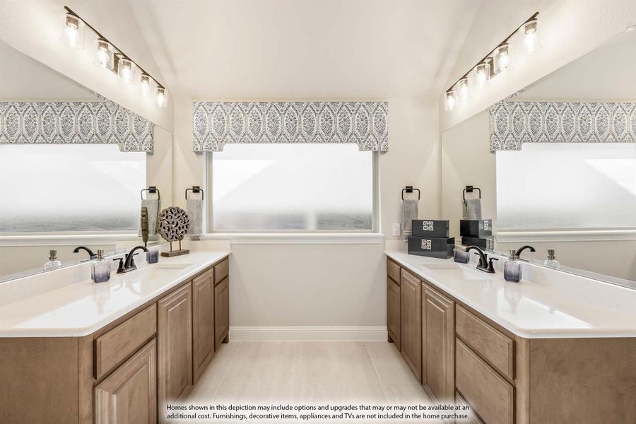 Dual vanity bathroom with wood cabinets, white countertops, and large mirrors on opposite walls Dual vanity bathroom with wood cabinets, white countertops, and large mirrors on opposite walls