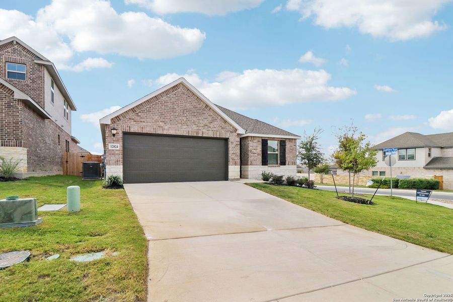 Front exterior of a new home in Arcadia Ridge - Premier Series, San Antonio, TX, highlighting curb appeal (Image 21).