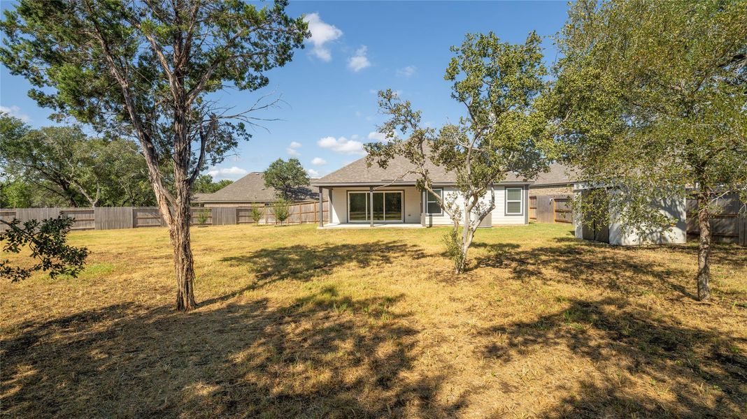 Rear view of house featuring a patio, a fenced backyard, and a shingled roof Rear view of house featuring a patio, a fenced backyard, and a shingled roof