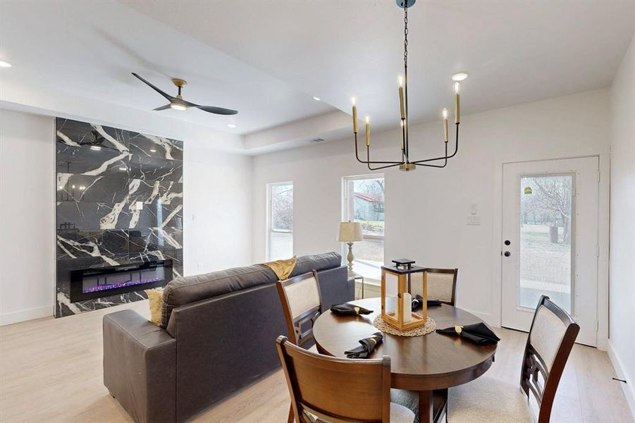 Dining area with ceiling fan and light wood-type flooring