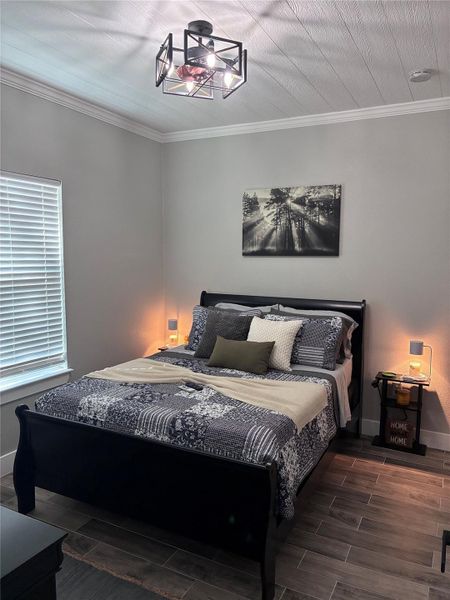 2nd Bedroom featuring ornamental molding and wood tiled floors