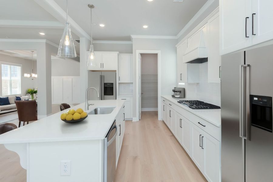 The kitchen includes beautiful white cabinets and a walk in pantry