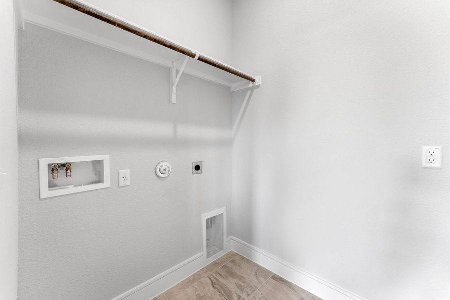 Functional utility room with tiled flooring and ample space for appliances. Functional utility room with tiled flooring and ample space for appliances.