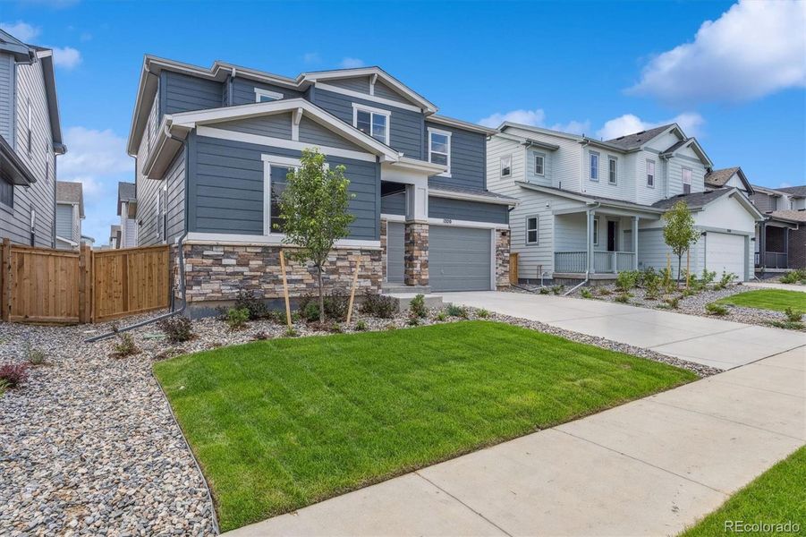 Front exterior of a new home in Floret Collection at Parkdale Commons, Erie, CO, highlighting curb appeal (Image 2).