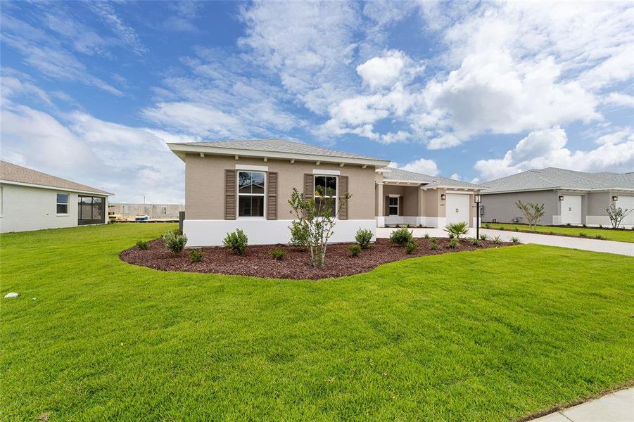 Exterior details and patio area of a home in On Top of the World Communities, Ocala (Image 1).