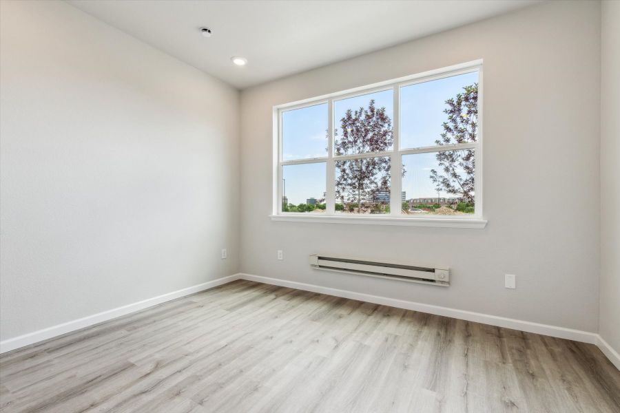 A room with a window and a wood floor. A room with a window and a wood floor.