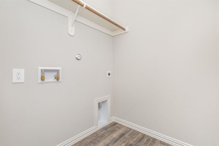 Washroom with electric dryer hookup, hardwood / wood-style floors, and washer hookup