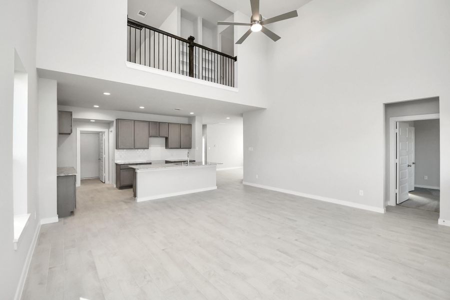 Family room flooded with natural light through the expansive windows. The premium tileflooring adds a touch of luxury to the space, creating the perfect setting for relaxing momentsand cherished gatherings with loved ones. Sample photo of completed home with similar floor plan. Actual colors and selections may vary.