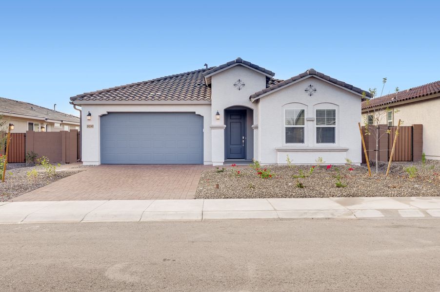 Front exterior of a new home in IronWing at Windrose, Litchfield Park, AZ, highlighting curb appeal (Image 1). Front exterior of a new home in IronWing at Windrose, Litchfield Park, AZ, highlighting curb appeal (Image 1).