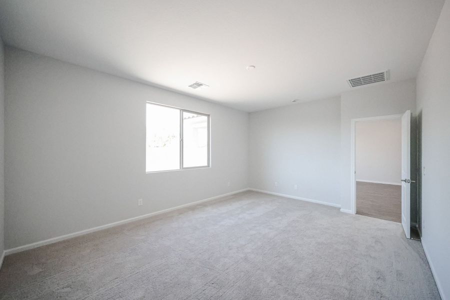 A room with a carpet and a door.