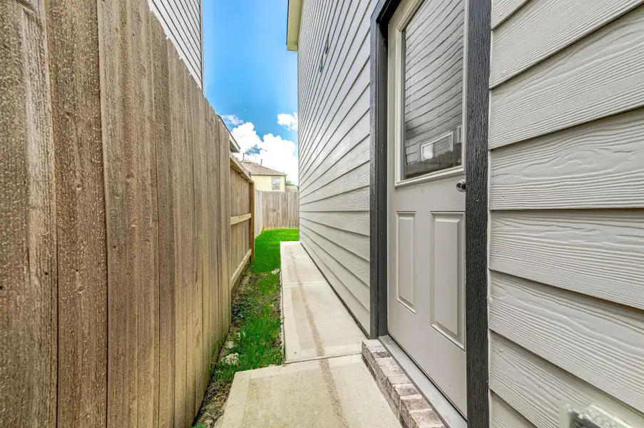 Backyard access door off the side of the home. Backyard access door off the side of the home.