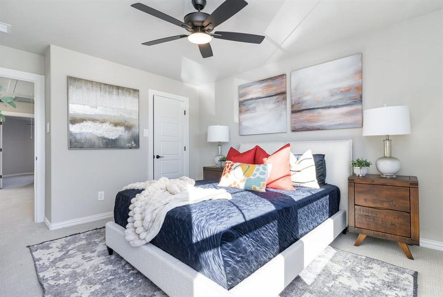 Carpeted bedroom featuring ceiling fan