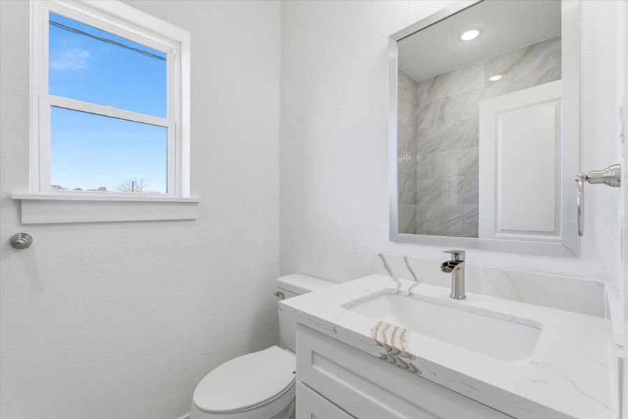 The first-floor full bathroom feels fresh and inviting, with quartz countertops, recessed lighting, and a shower-tub combination it's designed for everyday functionality with an elevated feel. The first-floor full bathroom feels fresh and inviting, with quartz countertops, recessed lighting, and a shower-tub combination it's designed for everyday functionality with an elevated feel.