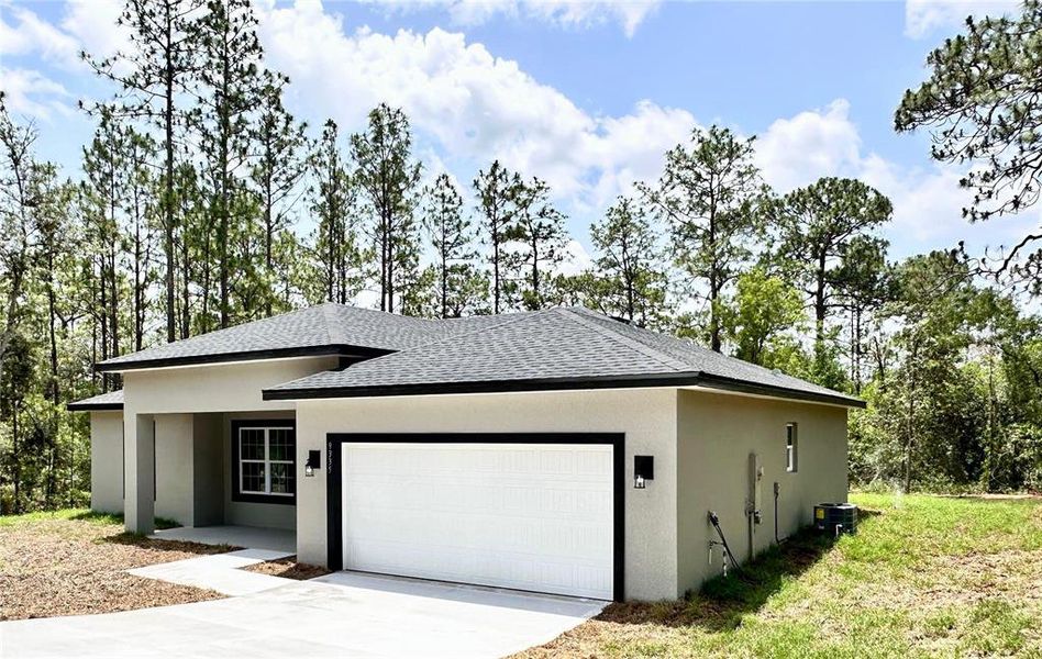 Front exterior of a new home in , Citrus Springs, FL, highlighting curb appeal (Image 1).