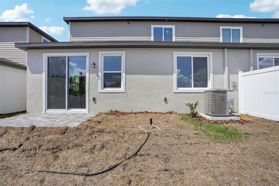 Front exterior of a new home in Cyrene at Minneola - Villas, Montverde, FL, highlighting curb appeal (Image 18). Front exterior of a new home in Cyrene at Minneola - Villas, Montverde, FL, highlighting curb appeal (Image 18).