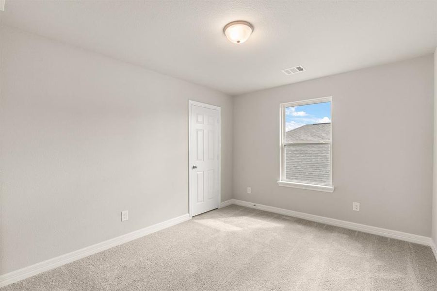 Your secondary bedroom features plush carpet, fresh paint, closet, and a large window that lets in plenty of natural lighting.