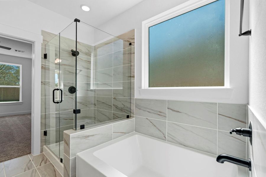 Enjoy the best of both worlds with a separate soaking tub for relaxation and a walk-in glass shower for convenience.