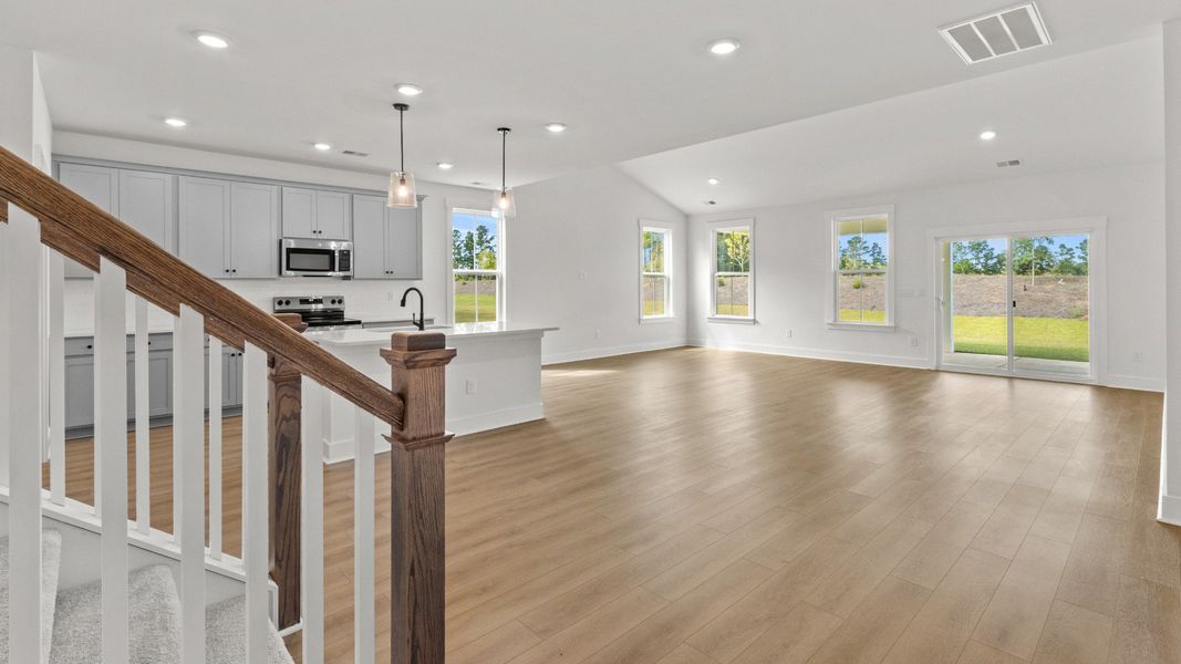 Spacious open-concept living with vaulted ceilings and natural light.